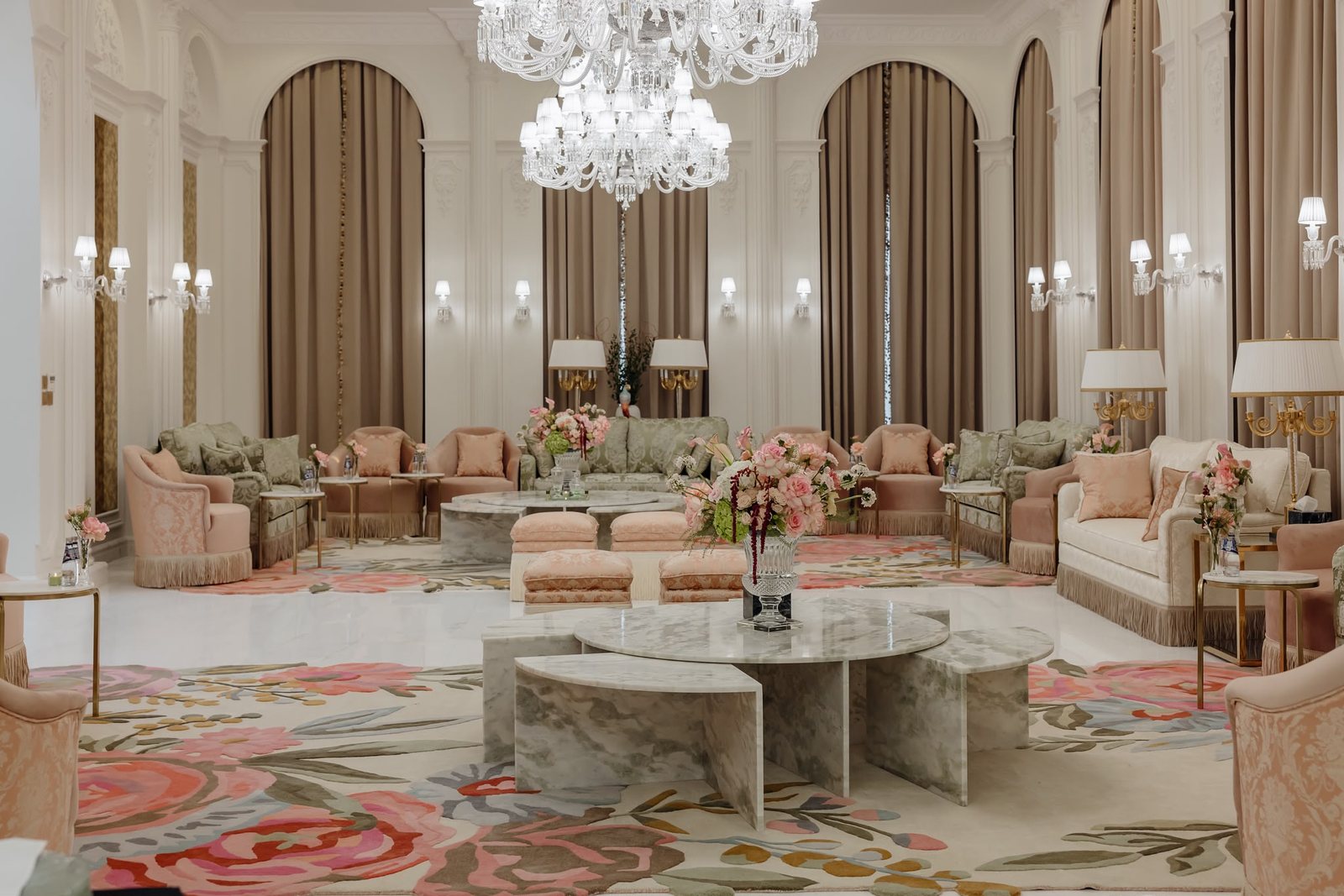Real project sage seating, blush chairs, crystal chandelier, marble table, and floral rug details